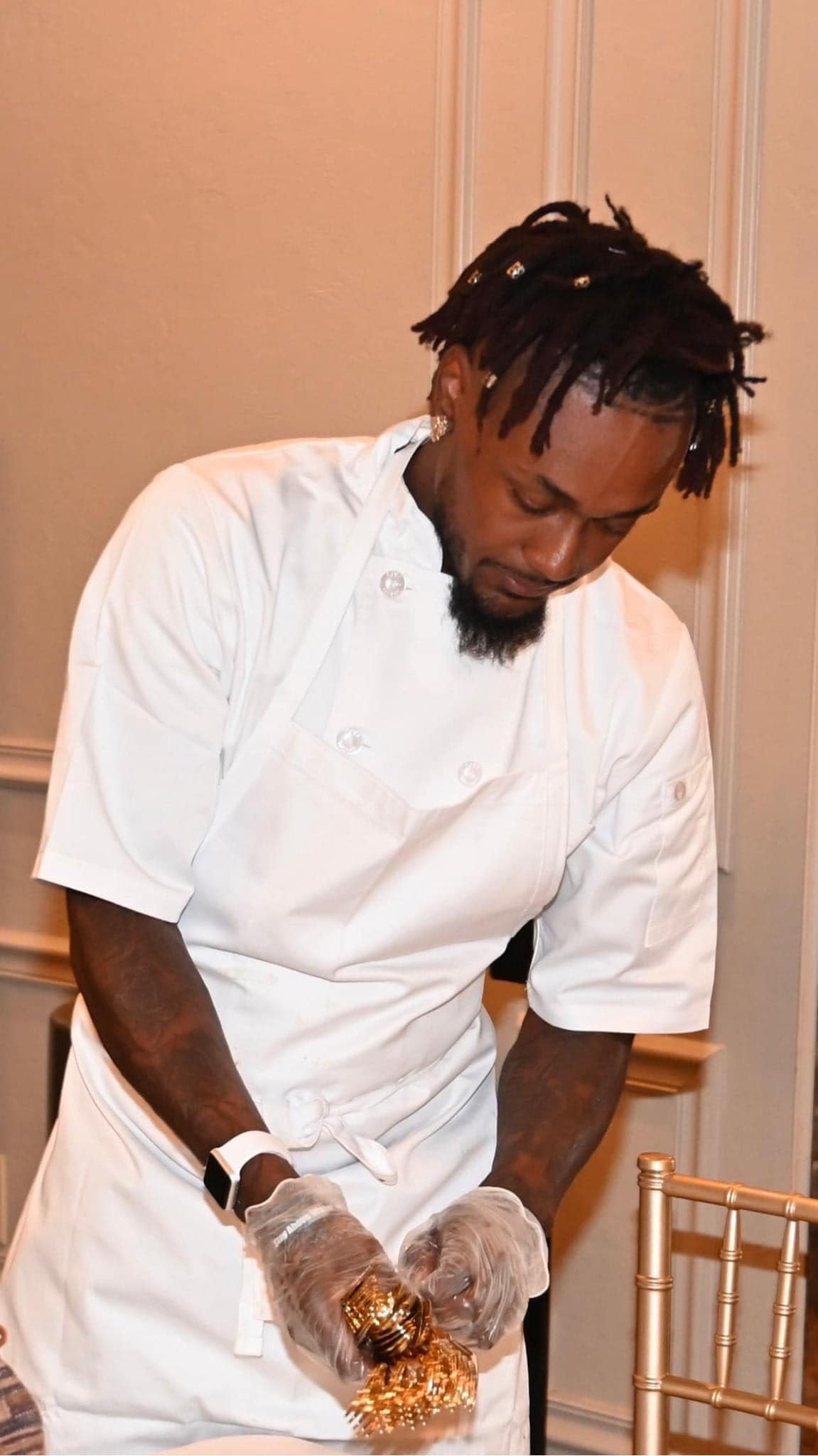 Chef Dee setting silverware for a catered event